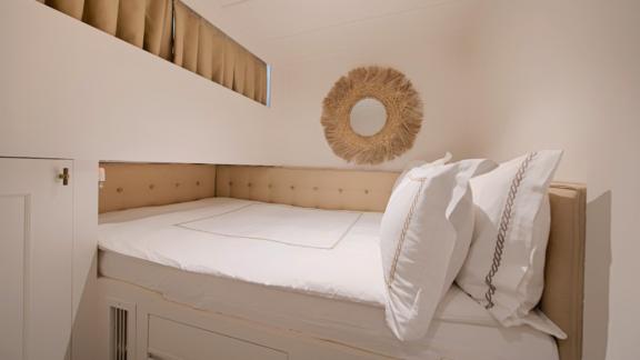 The single cabin on Liberte 11 offers simple comfort with elegant details and a comfortable bed.